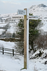 Old fashioned road sign showing Cadover bridge,sheepstor & Nattor in Dartmoor during winter
