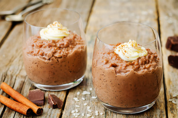 chocolate rice pudding decorated with whipped cream with cinnamon