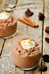 chocolate rice pudding decorated with whipped cream with cinnamon