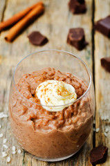 chocolate rice pudding decorated with whipped cream with cinnamon