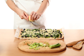 Grating cheese. Making Pizza with Leek and Spinach. Series.