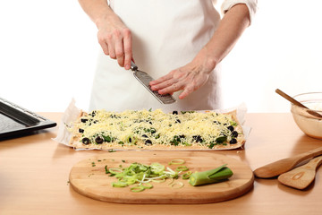 Grating cheese. Making Pizza with Leek and Spinach. Series.