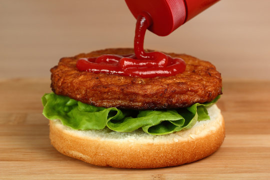 Spread Ketchup on Patty. Making Hamburger. Macro. Series.