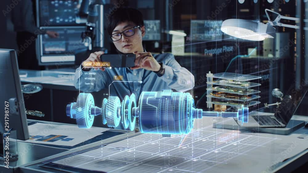 Aufkleber Industrial Engineer Works with Smartphone Using Augmented Reality Holographic Projection 3D Model of the Enlectric Motor Prototype. Development of Virtual Mixed Reality Application.