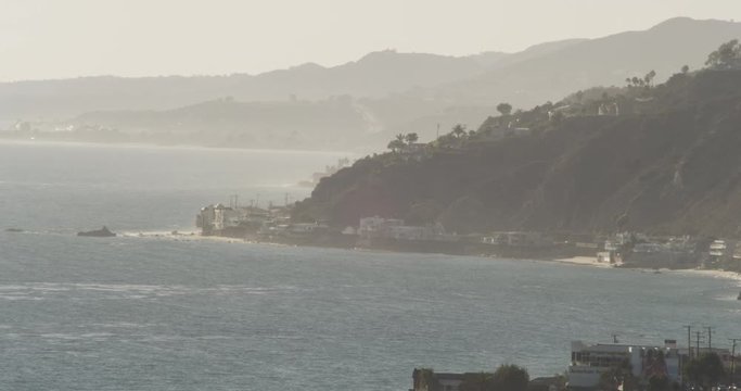 Foggy helicopter aerial shot of cliffs on California coast, overcast day