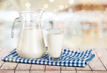 Glass of milk and bottle on  background