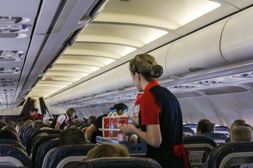 Stewardesses deliver drinks.