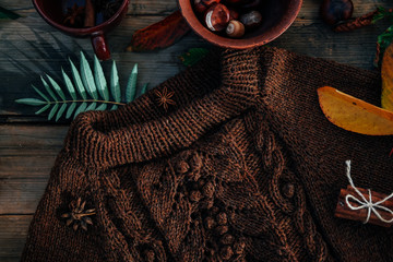 Handmade knitted clothes. Brown aran sweater with chestnuts and cinnamon.