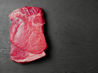 Juicy sirloin uncooked steak on a slate plate, Copy space, Raw meat display.