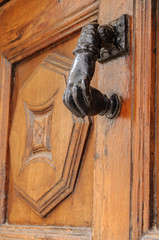 vintage old door knocker hand-shaped