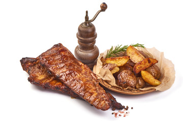 Roasted homemade pork ribs with baked crispy potatoes, Delicious barbecued hot ribs, isolated on white background