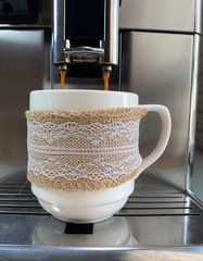 Pour coffee from a coffee machine.