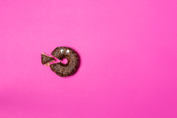 Chocolate donut cut in triangle with eyes, top view