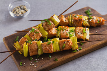 Grilled salmon skewers. Salmon fish with leeks on skewers