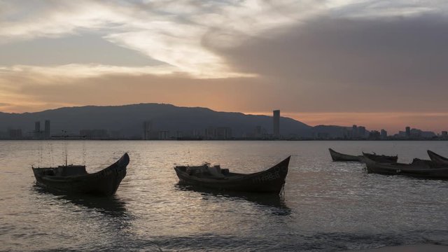 Timelapse Sunset busy Penang port with during sunset hour with ray from sun. Can view the island scenery and building KOMTAR at the background.