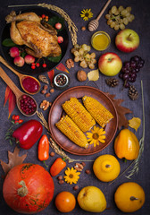 Chicken or turkey, autumn fruits and vegetables. Thanksgiving food concept. Harvest or Thanksgiving background. Flat lay, vertical image