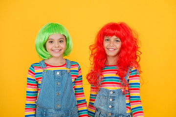 Happy little girls smiling faces. Anime fan. Cheerful friends in bright colorful wigs. Anime cosplay party concept. Happy childhood concept. Anime culture influence. Invitation for anime party