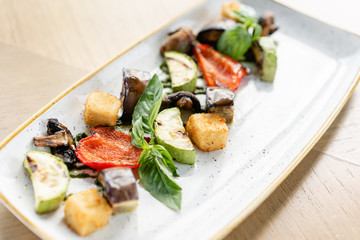 Grilled vegetables with feta cheese. Serving on a plate on a table. Barbecue restaurant menu, a series of photos of different dishes