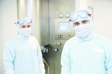Portrait of two workers at pharmaceutical factory