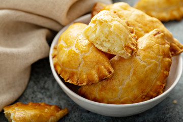 Hand pies, pasties, samosas or pierogies with potato filling golden baked © fahrwasser