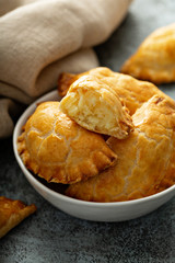 Hand pies, pasties, samosas or pierogies with potato filling golden baked © fahrwasser