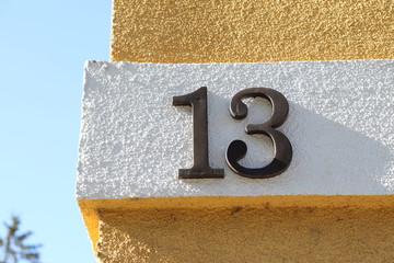 number thirteen written on yellow and white wall