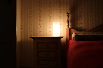 cozy room night stand with lamp near bed