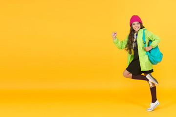 Teen fashion. Schoolgirl street style clothes with cute backpack. Backpack as fashion accessory. Girl little fashionable cutie carry backpack. Modern backpack for daily life. Fit backpack correctly