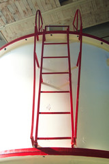 Red metal spar-ladder on a white wall