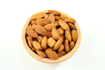 Almonds in a wood bowl on white background