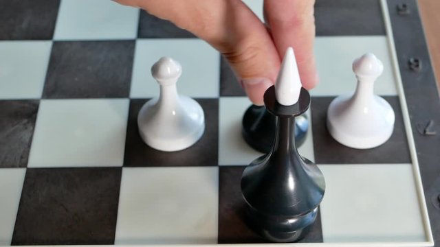 conceptual video of bribery, traitor or betrayer. black king, surrounded by white figures give bribe then white chess pawn become black and throws out another figures, defending his master. 4k footage