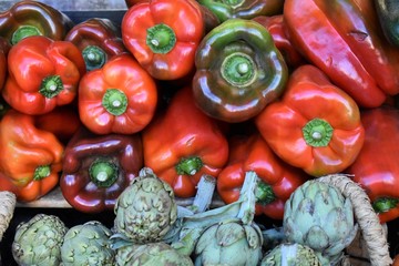 Artichokes and peppers of different colors washed and exposed for sale