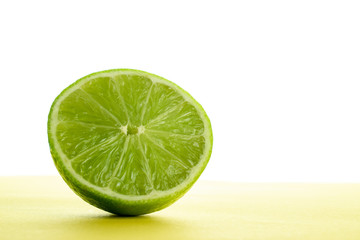 Lime light. Fresh juicy green lemon isolated on white background