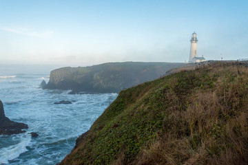 Fototapeta na wymiar Lighthouse in Fog at the Pacific Coast in Oregon 02