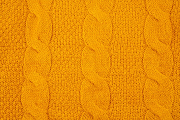 Texture of orange woolen knitted sweater
