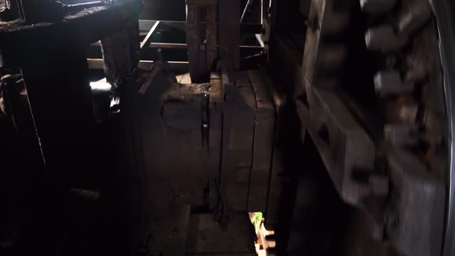 Close up gears of mill stones processing grain inside a windmill at zaanse schans near amsterdam, netherland. Slow motion