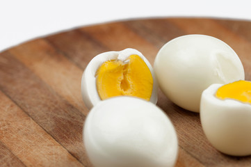 Egg on wooden board isolated on white background