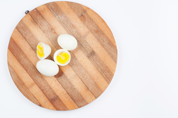 Egg on wooden board isolated on white background