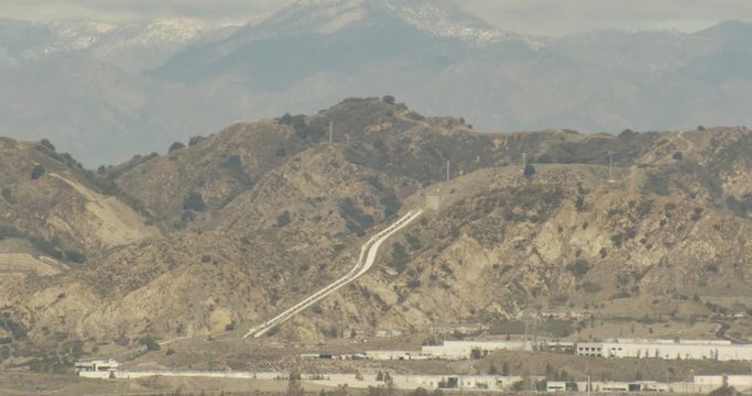 Aerial shot, day, distant view of desert mountain, water runoff system, drone