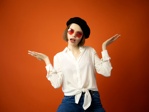 Girl in Basque Beret, red glasses and white blouse isolated on white background. Fashion concept. Big red lips. Copy space. Art critic
