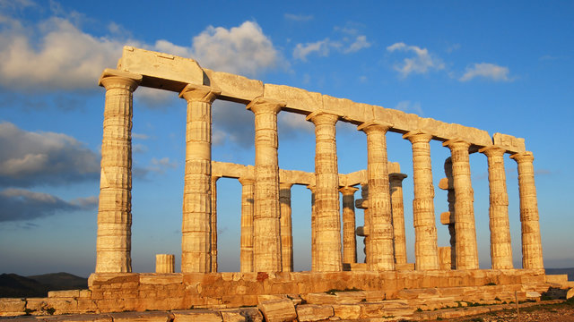 Ancient greek colonnade at sunset on deep blue sky background