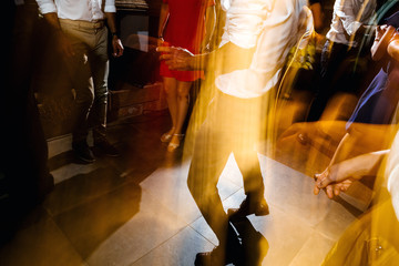 Silhouettes of your caucasian and african ethnicity group of people dancing at a party enjoying the great atmosphere and music