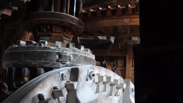 Close up of mill stones processing grain inside a windmill at zaanse schans near amsterdam, netherland. Slow motion