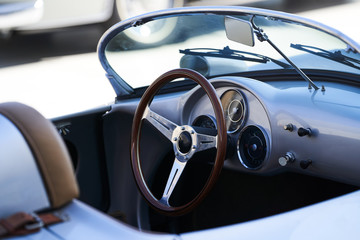 Vintage retro car interior, close-up. Old automobile steering wheel