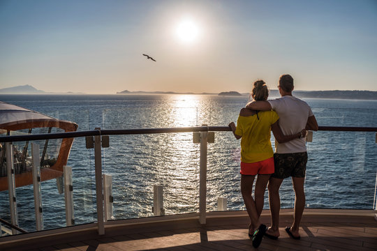 Couple Is On A Cruise Watching Beautiful  Sunset. Open Deck On A Cruise Ship. Bird Is Flying In The Sky.