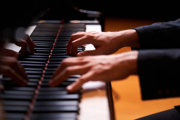 Obraz premium Closeup man's hand playing piano. Music performer's hand