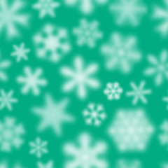 Christmas seamless pattern of white defocused snowflakes on turquoise background