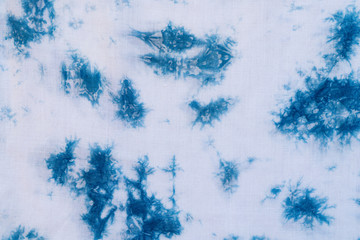 Pattern of blue dye on cotton cloth, Dyed indigo fabric background and textured