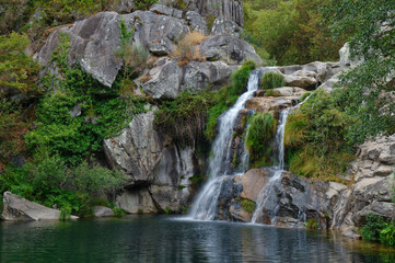 Fototapeta na wymiar Waterfall at a natural spot called Poço Negro in Carvalhais, Sao Pedro do Sul, Portugal