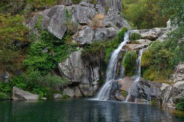 Fototapeta na wymiar Waterfall at a natural spot called Poço Negro in Carvalhais, Sao Pedro do Sul, Portugal
